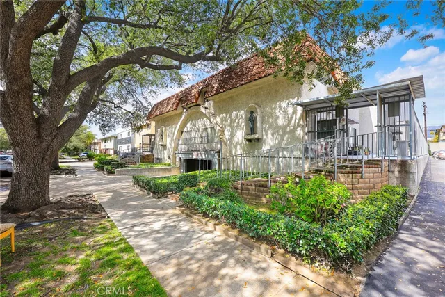 a front view of a building with a garden