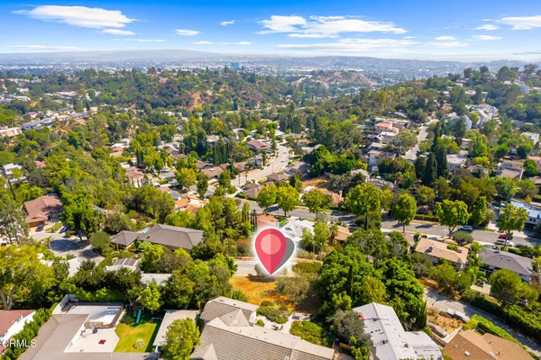 an aerial view of a house with a swimming pool