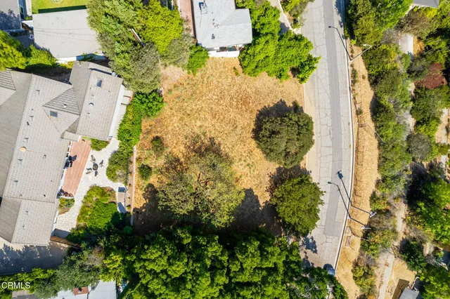 an aerial view of a house with yard
