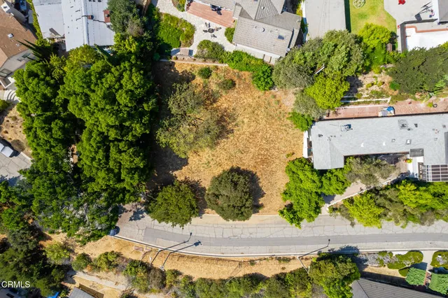 an aerial view of a house with a yard