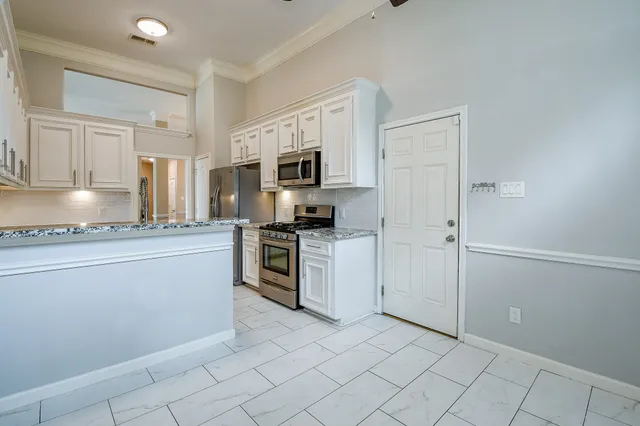 a kitchen with granite countertop cabinets and steel stainless steel appliances
