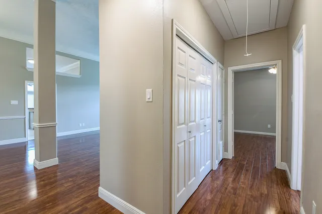 a view of a hallway with wooden floor