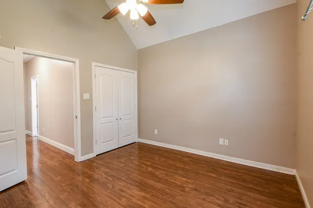 a view of an empty room with wooden floor