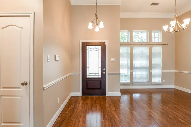 a view of a room with wooden floor and a window