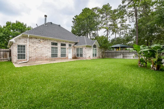 a front view of a house with a garden and yard
