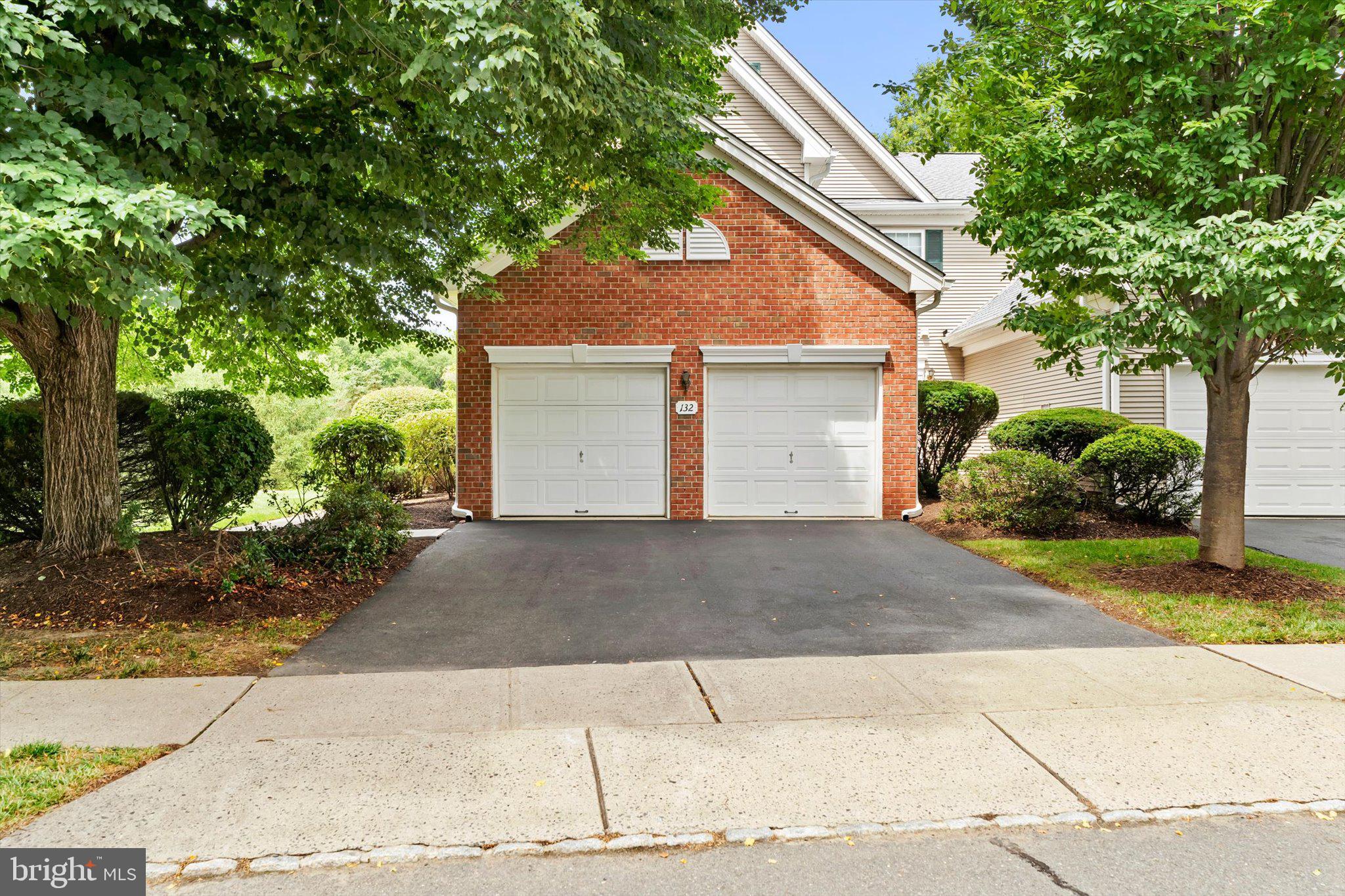 132 Coburn Road Pennington, NJ 08534 - Photo 2 of 50 Charming brick facade with lush greenery.