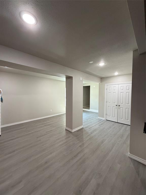 4812 Barbara Road River Oaks, TX 76114 - Photo 17 of 20 an empty room with wooden floor and windows