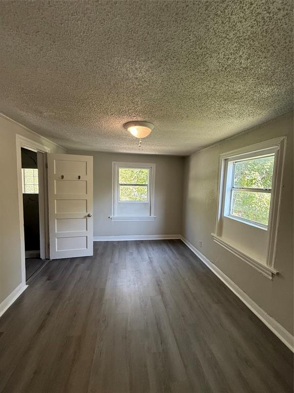 4812 Barbara Road River Oaks, TX 76114 - Photo 18 of 20 an empty room with wooden floor and windows