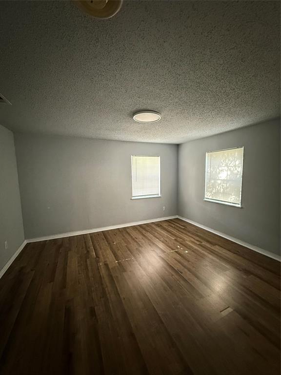 4812 Barbara Road River Oaks, TX 76114 - Photo 4 of 20 an empty room with wooden floor and windows
