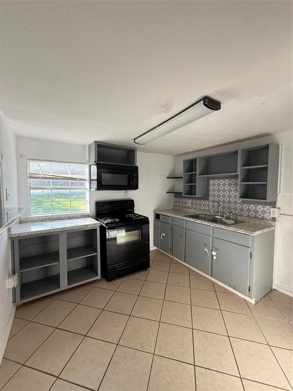 4812 Barbara Road River Oaks, TX 76114 - Photo 10 of 20 a kitchen with stainless steel appliances granite countertop a stove a sink and a microwave