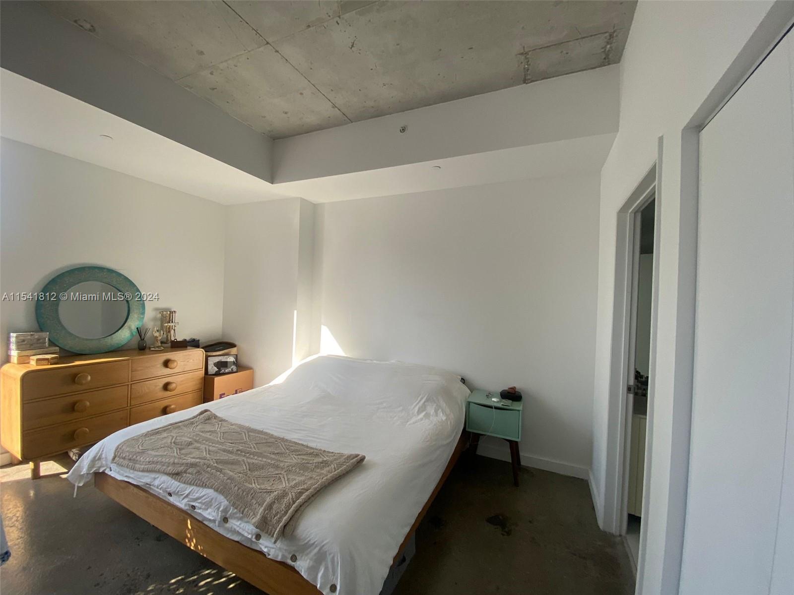 151 Southeast 1st Street, Unit 2707 Miami, FL 33131 - Photo 6 of 12 a bedroom with a bed and window