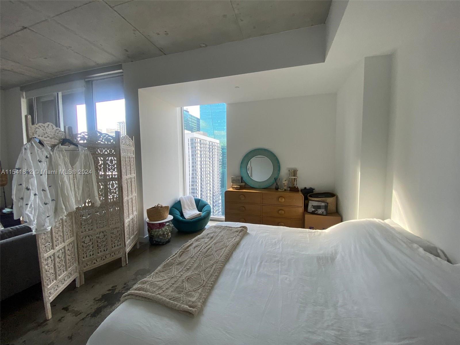 151 Southeast 1st Street, Unit 2707 Miami, FL 33131 - Photo 8 of 12 a bedroom with bed and wooden floor