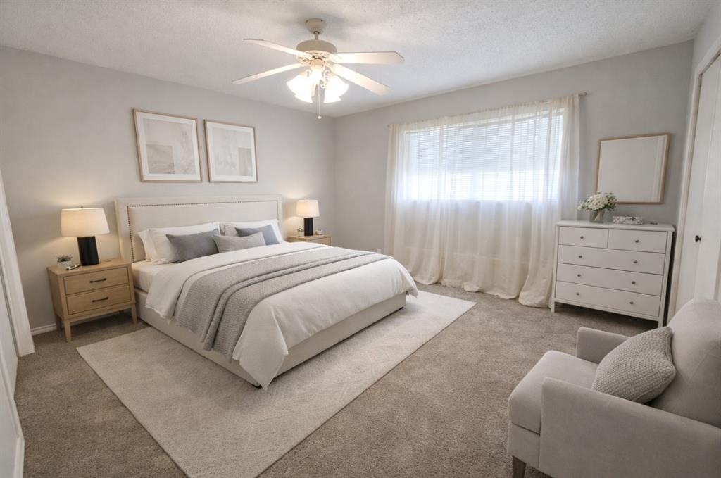 2302 Shiloh Street Denison, TX 75020 - Photo 9 of 16 a spacious bedroom with a bed a couch and a chandelier