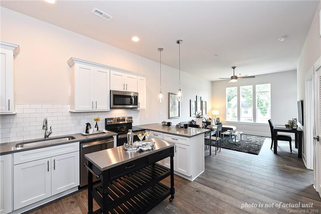 935 McAlway Road, Unit 201 Charlotte, NC 28211 - Photo 2 of 21 a kitchen with lots of counter top space and dining table
