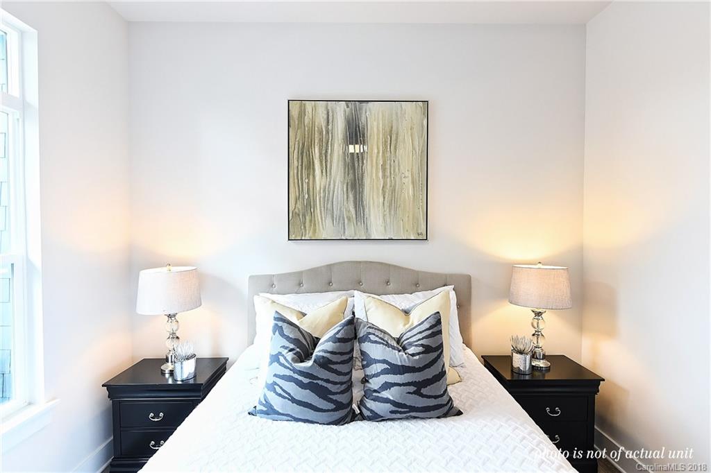 935 McAlway Road, Unit 201 Charlotte, NC 28211 - Photo 14 of 21 a bed room with furniture and a lamp