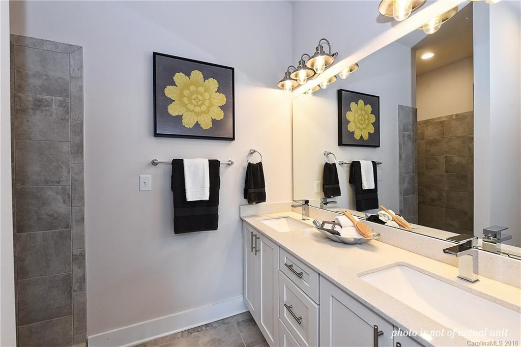 935 McAlway Road, Unit 201 Charlotte, NC 28211 - Photo 16 of 21 a bathroom with a double vanity sink and a mirror