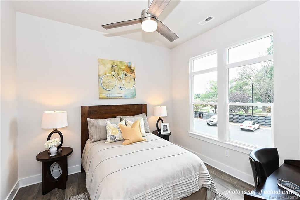 935 McAlway Road, Unit 201 Charlotte, NC 28211 - Photo 18 of 21 a bedroom with a bed and a large window