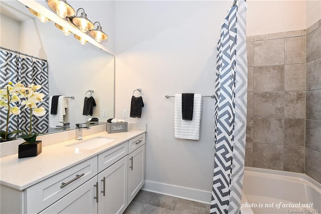 935 McAlway Road, Unit 201 Charlotte, NC 28211 - Photo 19 of 21 a bathroom with a sink a mirror and a shower
