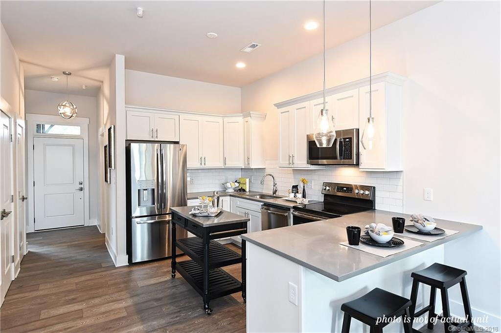 935 McAlway Road, Unit 201 Charlotte, NC 28211 - Photo 3 of 21 a kitchen with refrigerator cabinets and wooden floor