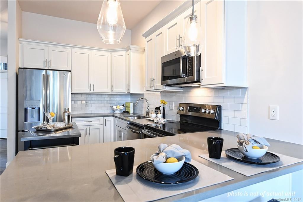 935 McAlway Road, Unit 201 Charlotte, NC 28211 - Photo 5 of 21 a kitchen with stainless steel appliances a sink a stove a microwave and cabinets