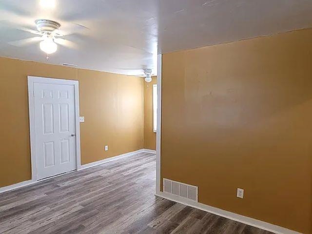 2344 Warren Street Memphis, TN 38106 - Photo 2 of 9 wooden floor in an empty room with a window