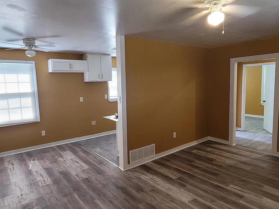 2344 Warren Street Memphis, TN 38106 - Photo 3 of 9 an empty room with wooden floor and windows