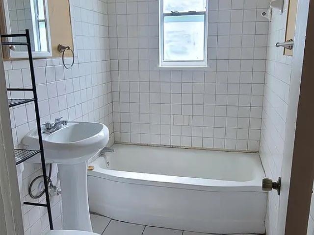 2344 Warren Street Memphis, TN 38106 - Photo 5 of 9 a white bath tub sitting next to a white sink