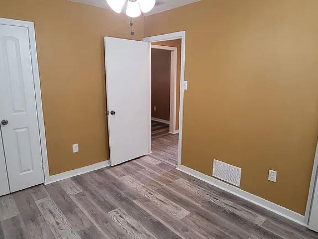2344 Warren Street Memphis, TN 38106 - Photo 7 of 9 an empty room with wooden floor and entrance