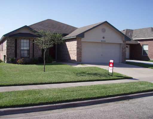 8001 Rock Crest Drive Corpus Christi, TX 78414 - Photo 1 of 4 a front view of a house with a yard and garage