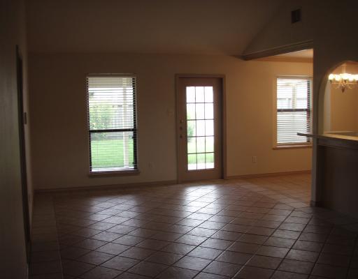 8001 Rock Crest Drive Corpus Christi, TX 78414 - Photo 4 of 4 an empty room with windows and entrance