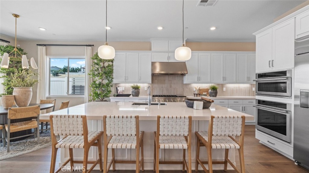 a large kitchen with a table and chairs