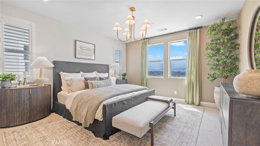 29503 Corte Azulejo Valencia, CA 91354 - Photo 15 of 34 a spacious bedroom with a bed and a chandelier