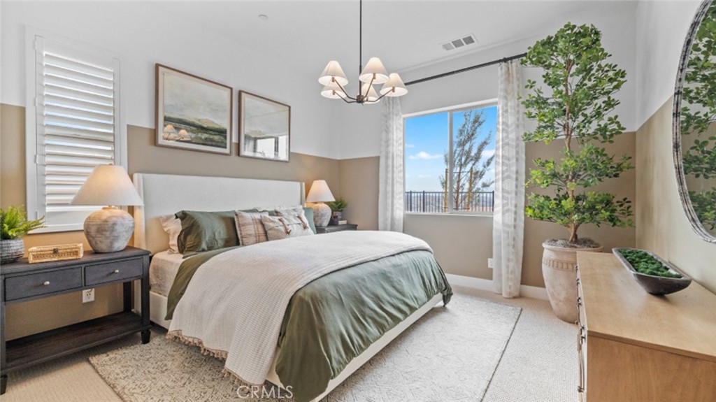 29503 Corte Azulejo Valencia, CA 91354 - Photo 21 of 34 a bedroom with a bed and a chandelier