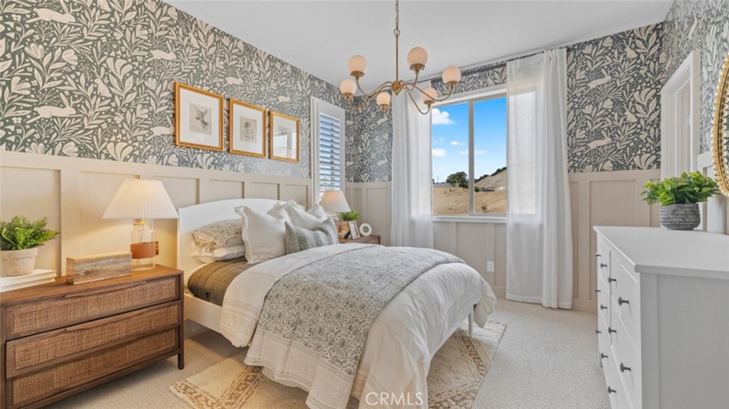 29503 Corte Azulejo Valencia, CA 91354 - Photo 24 of 34 a bedroom with a large bed and a chandelier