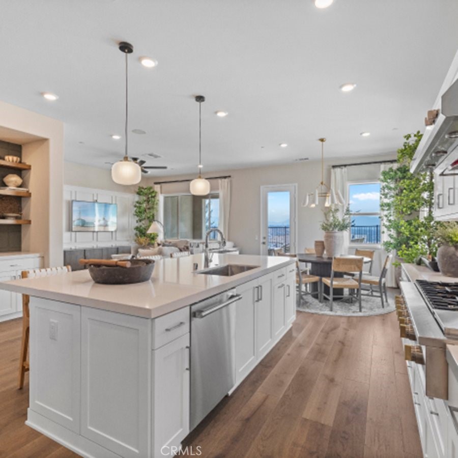 29503 Corte Azulejo Valencia, CA 91354 - Photo 3 of 34 a kitchen with sink stove and white cabinets with wooden floor