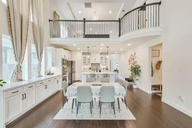 a view of a a dining room with furniture window and wooden floor