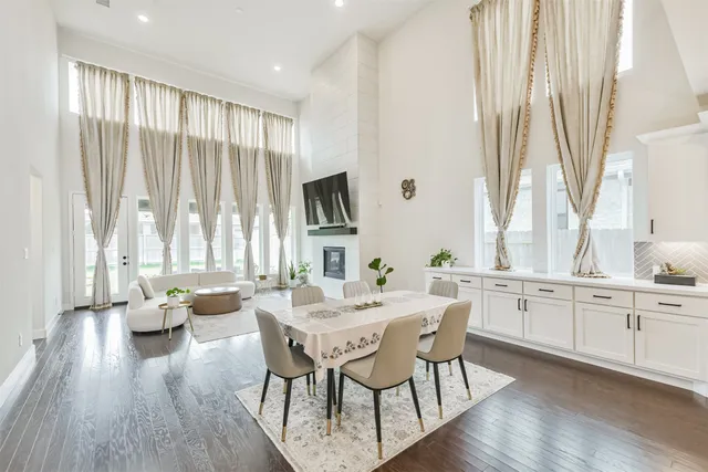 a kitchen with stainless steel appliances kitchen island granite countertop a table chairs and a stove