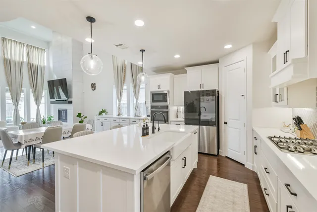 a large kitchen with a table and chairs