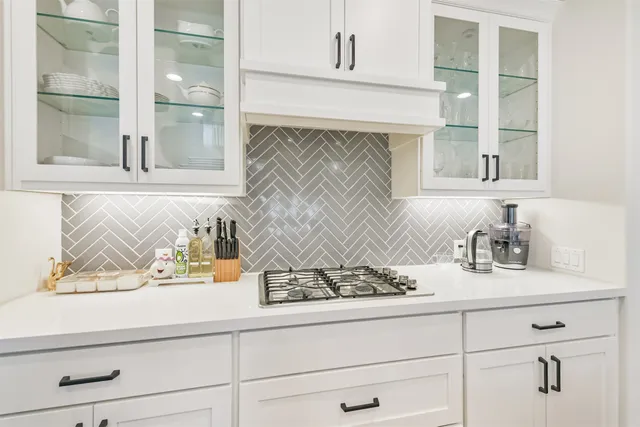 a kitchen with stainless steel appliances a refrigerator sink and cabinets