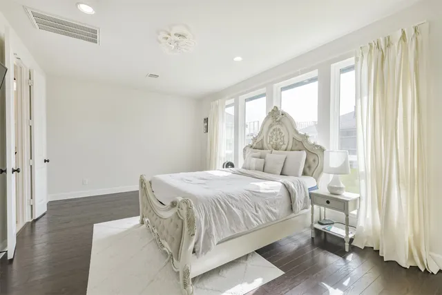 a living room with a bed furniture and a large window