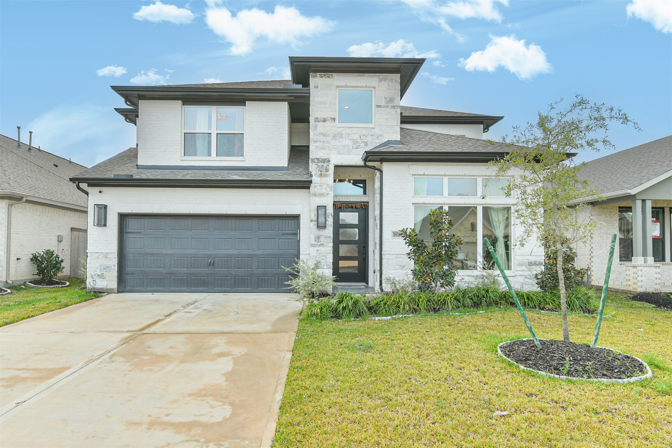 19319 Wild Sabino Way Tomball, TX 77377 - Photo 2 of 46 a front view of a house with a yard