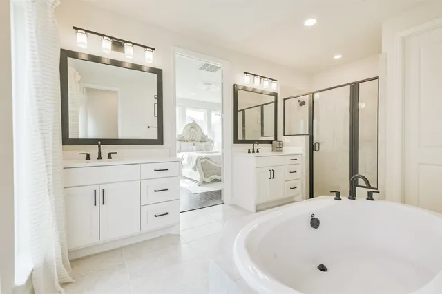a bathroom with a double vanity sink mirror and