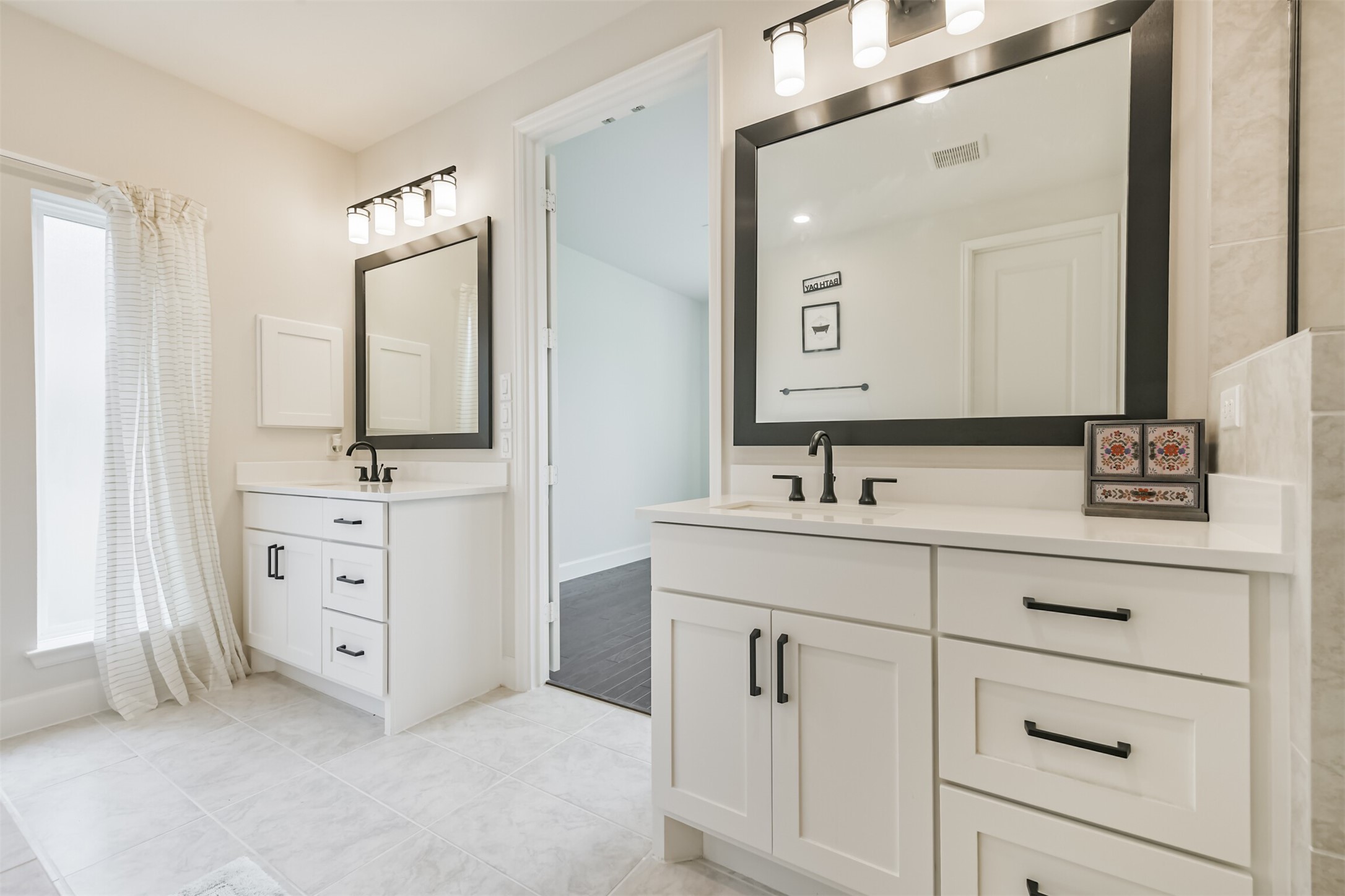 19319 Wild Sabino Way Tomball, TX 77377 - Photo 24 of 46 a bathroom with a double vanity sink mirror and