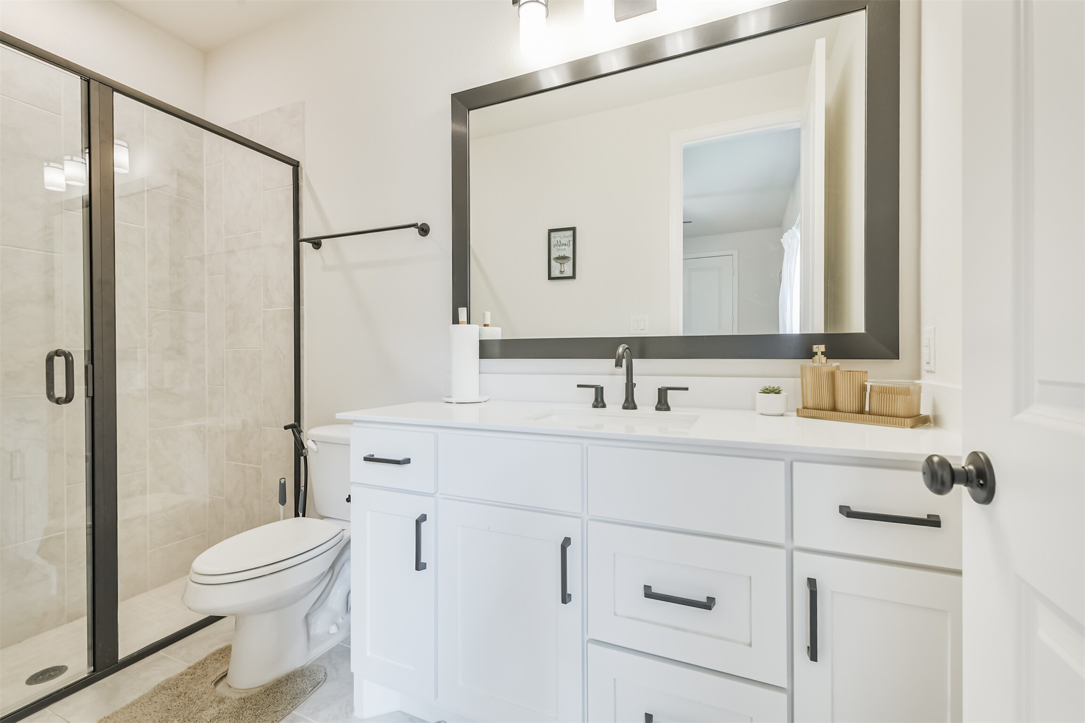 19319 Wild Sabino Way Tomball, TX 77377 - Photo 29 of 46 a bathroom with a sink a toilet and a mirror