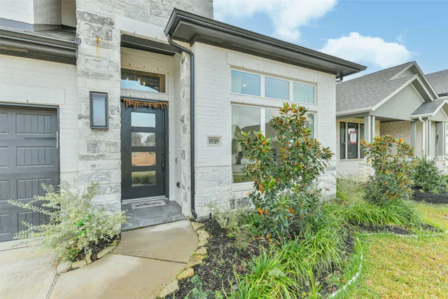 a view of a hallway with wooden floor and entryway