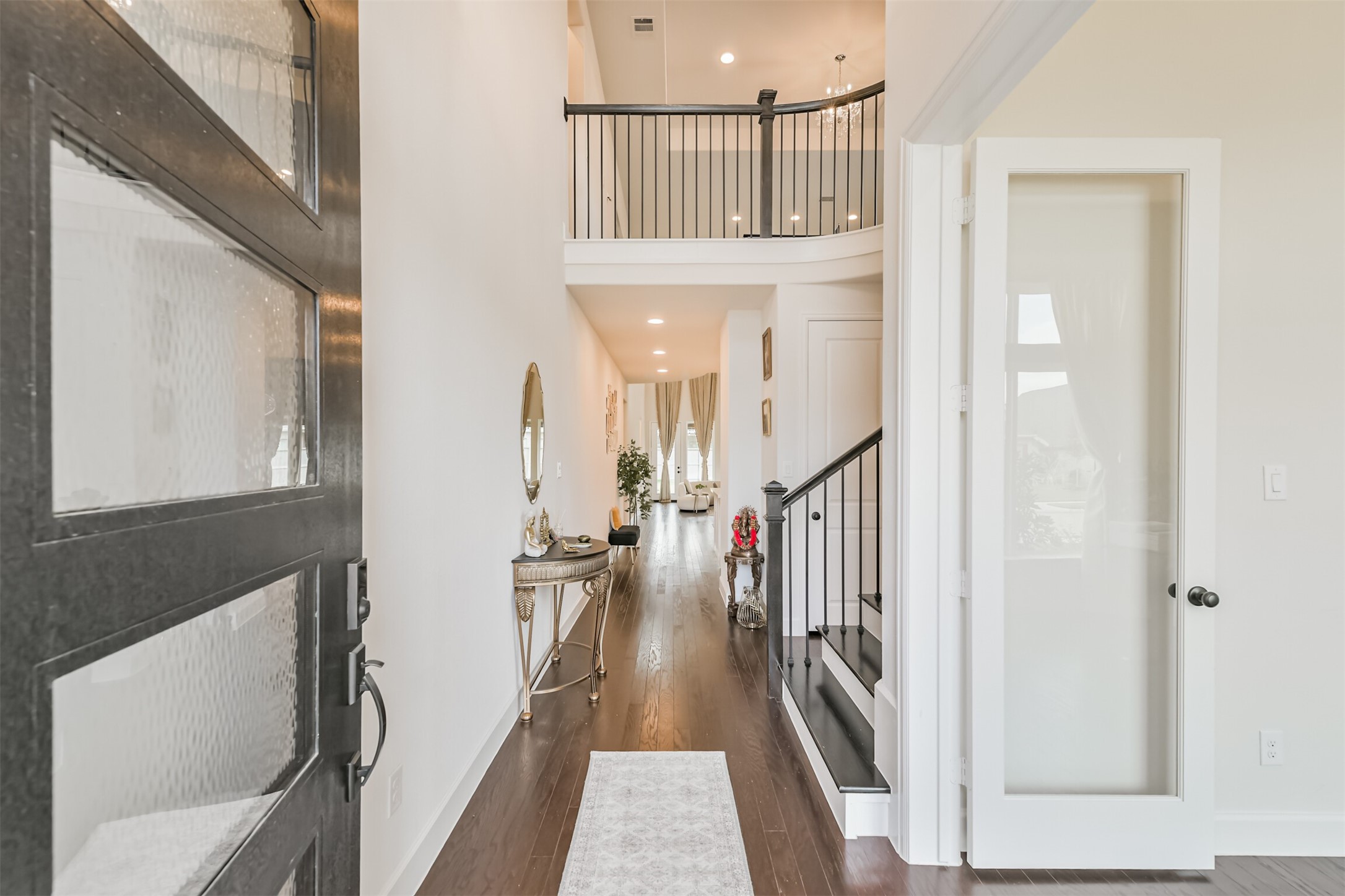 19319 Wild Sabino Way Tomball, TX 77377 - Photo 4 of 46 a view of a hallway with wooden floor and entryway