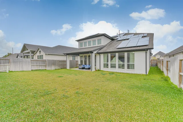 a view of a house with a swimming pool and a yard