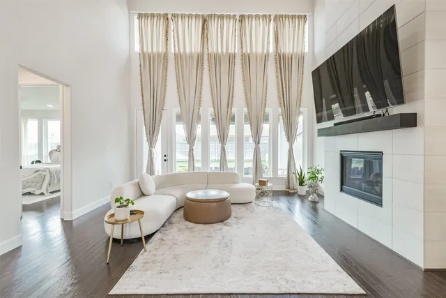 a living room with furniture and a chandelier