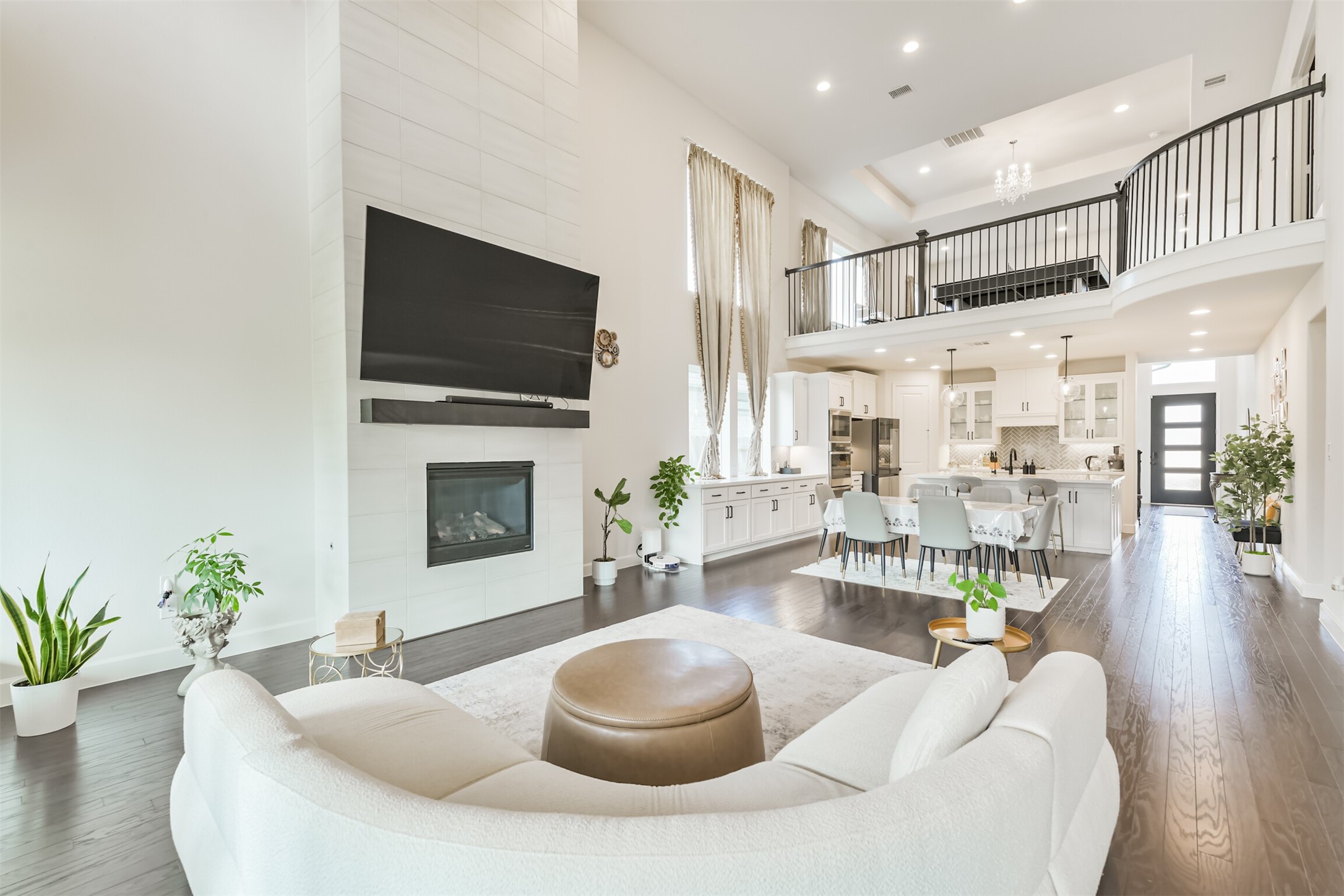 19319 Wild Sabino Way Tomball, TX 77377 - Photo 9 of 46 a living room with furniture a flat screen tv and a fireplace