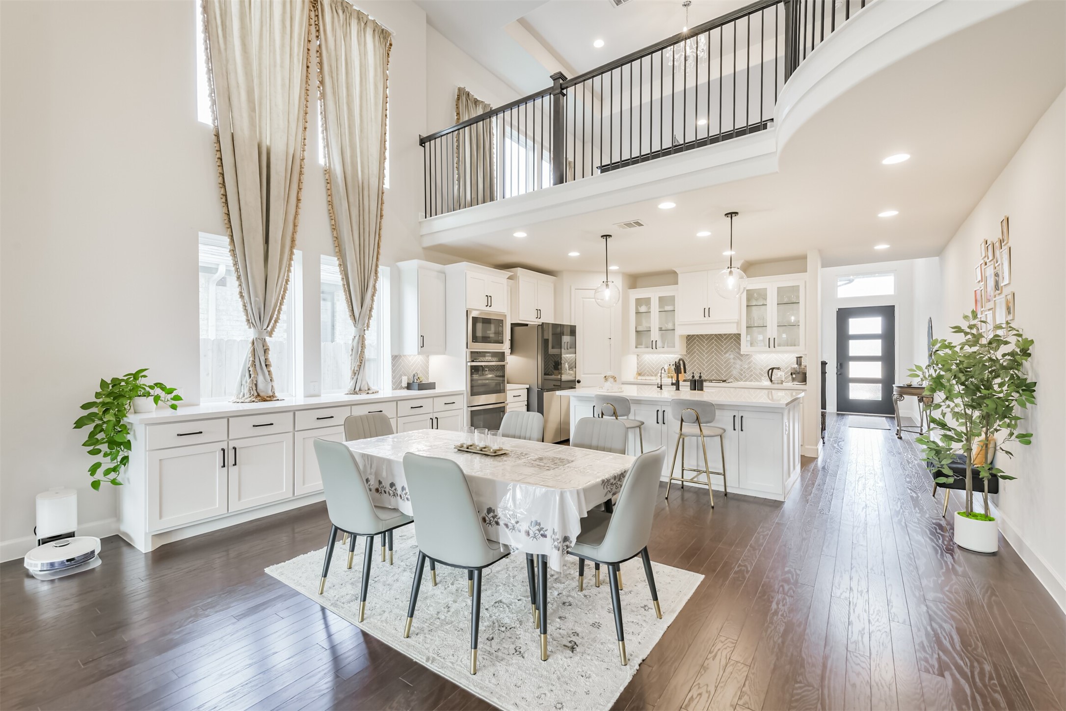 19319 Wild Sabino Way Tomball, TX 77377 - Photo 10 of 46 a dining room with furniture potted plants and wooden floor